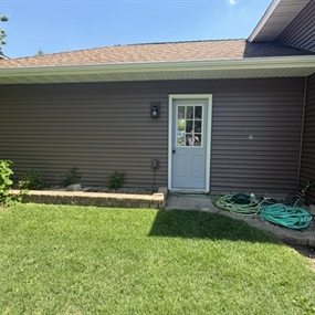 Back exterior showcasing new structural siding and trim work
